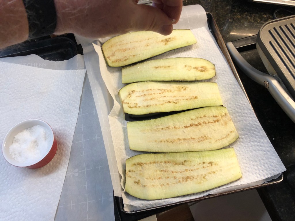  Sprinkle the eggplant slices with sea salt on both sides and let sit for 10 minutes to draw out moisture. Pat dry with paper towels to remove excess liquid