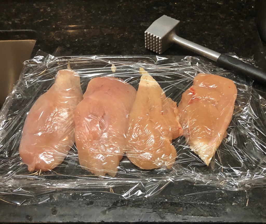Cover the chicken breasts with a sheet of plastic wrap...