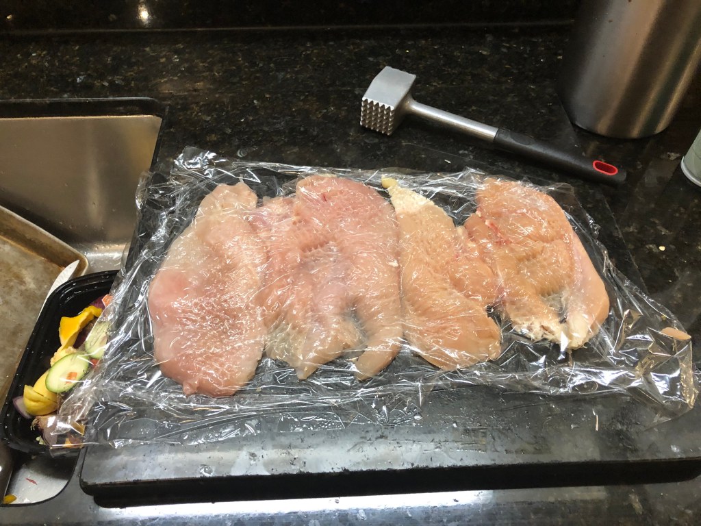 Use your meat mallet to flatten out the chicken. This will cut down cooking time for the chicken and helps ensure veggies and chicken will be ready at the same time